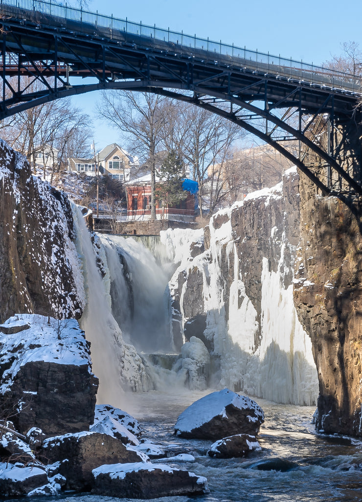 Paterson, New Jersey - USA - Jan 30, 2022 Vertical closeup view of the partially frozen falls at historic Paterson Great Falls National Historical Park during the winter