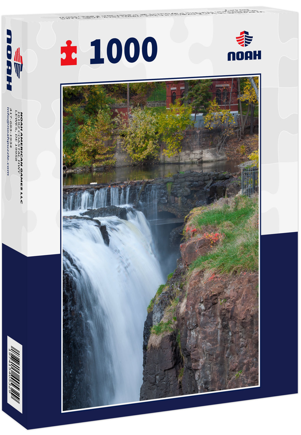 Waterfall in long exposure between rock with a red building in the background at Paterson Falls, New Jersey