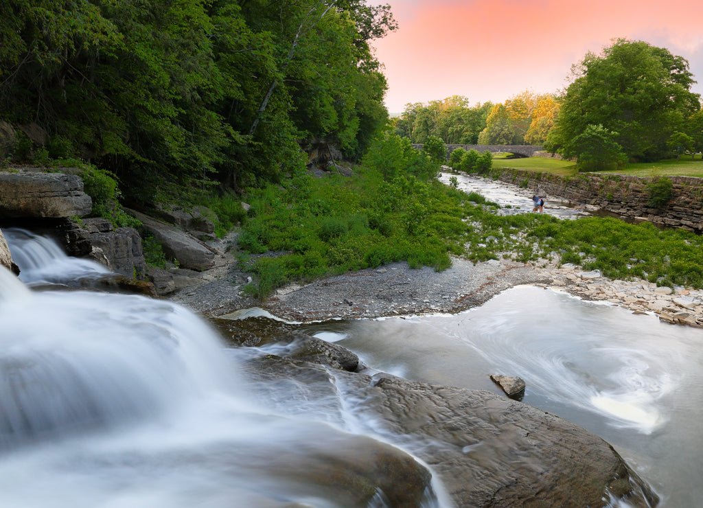 Overview of water falls at sunset in Taughannock Falls State Park. Taughannock Falls State Park is a 750-acre state park located in the town of Ulysses in Tompkins County, New York, USA