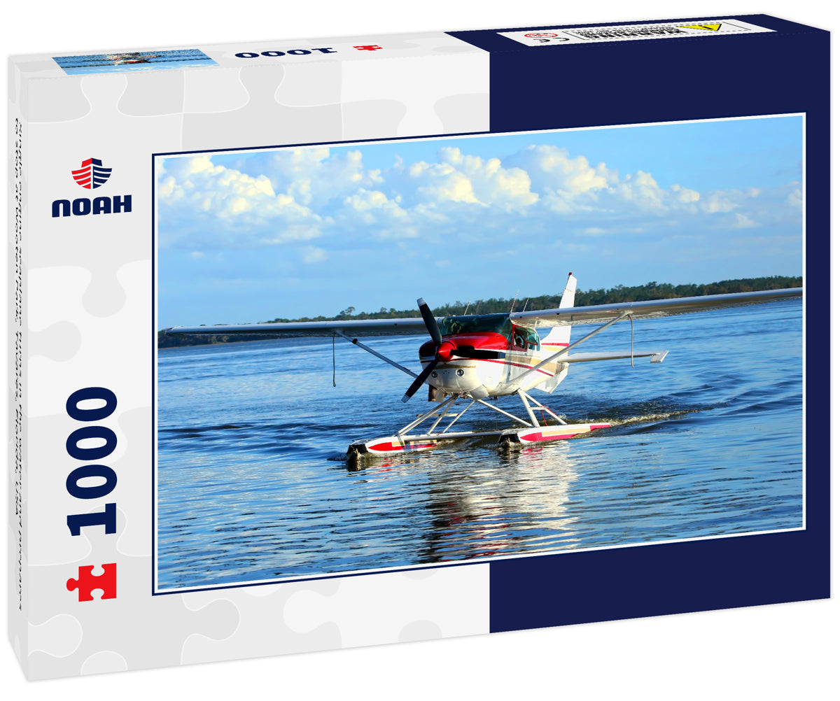 Single engine seaplane turns in the water and prepares to stop at Wooten Park, Tavares, Florida, USA
