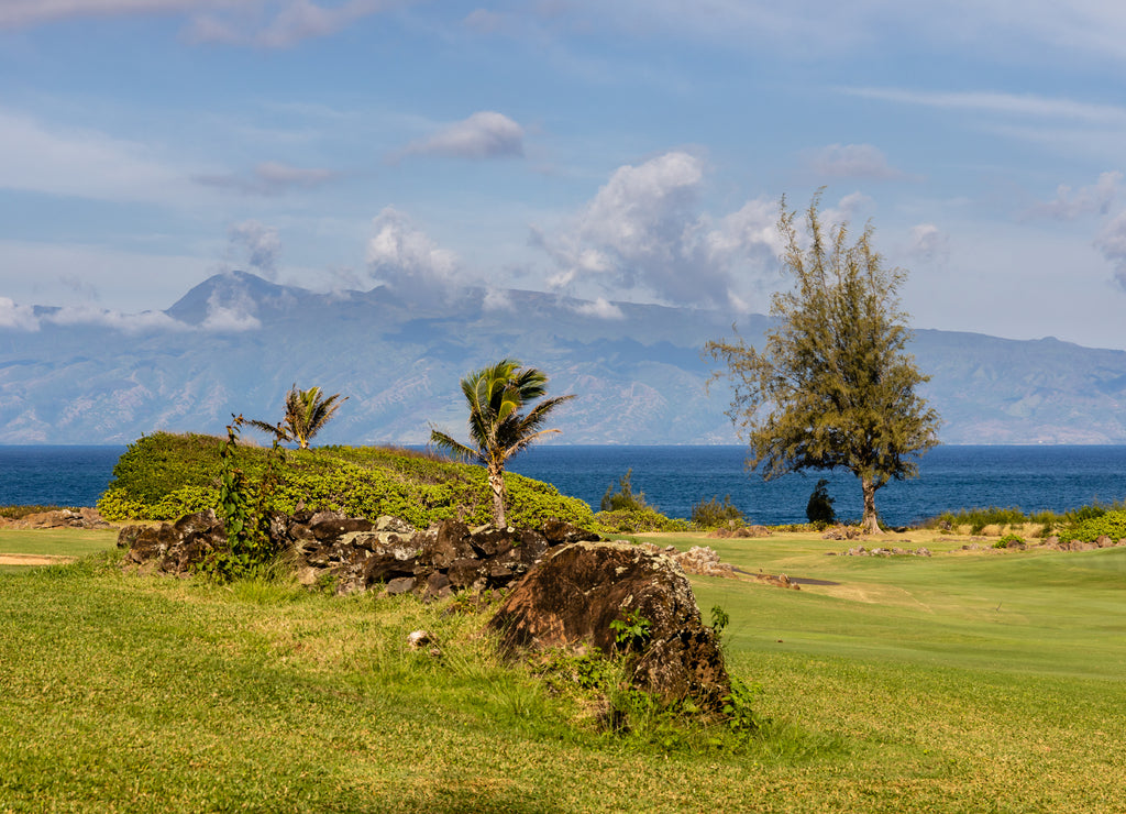 The mountains of Molokai under the clouds from Makaluapuna Point and the dragon's teeth in Maui, Hawaii