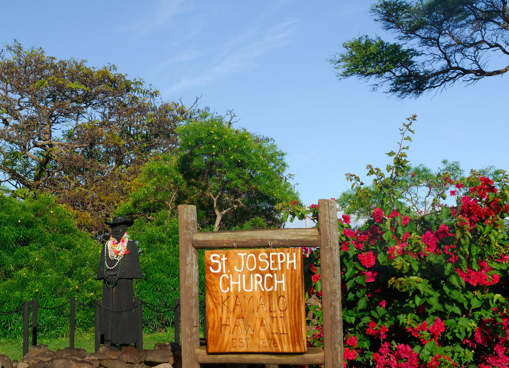 Statue of Father Damien at sunset at St Joseph Church Kamalo Molokai Hawaii