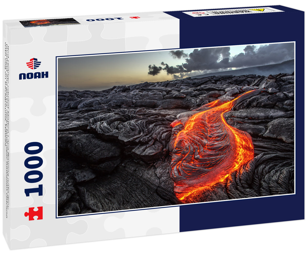 Red Orange vibrant Molten Lava flowing onto grey lavafield and glossy rocky land near hawaiian volcano with vog on background, Hawaii