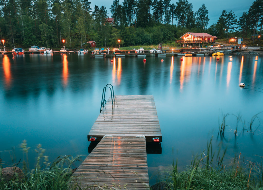 Sweden. Beautiful Wooden Pier Near Lake In Summer Evening Night. Lake Or River Landscape