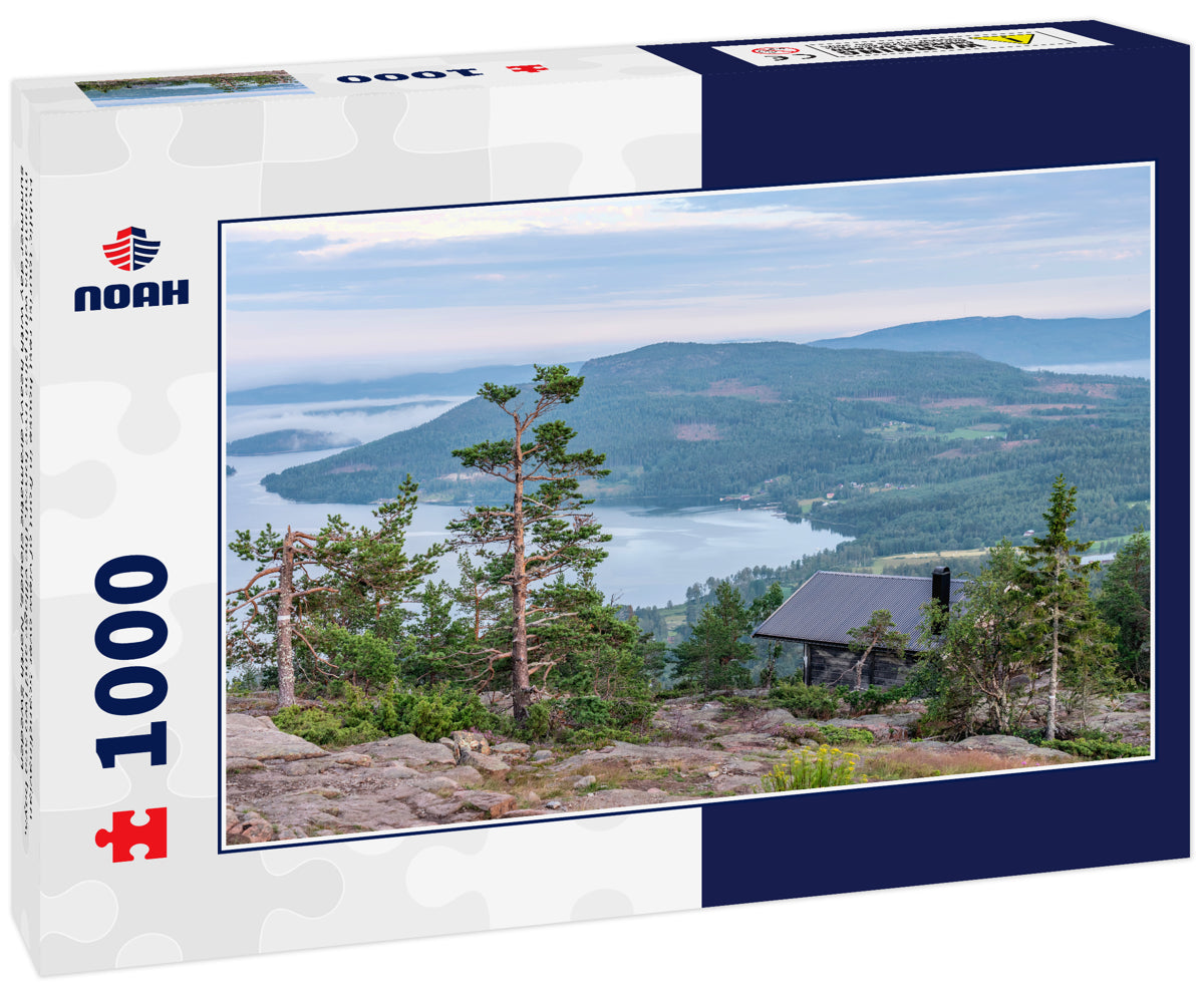 Public tourist rest house in front of view over Scandinavian mountains with pine tree forest, the village and two sea bays, summer day with heavy dramatic clouds, North Sweden