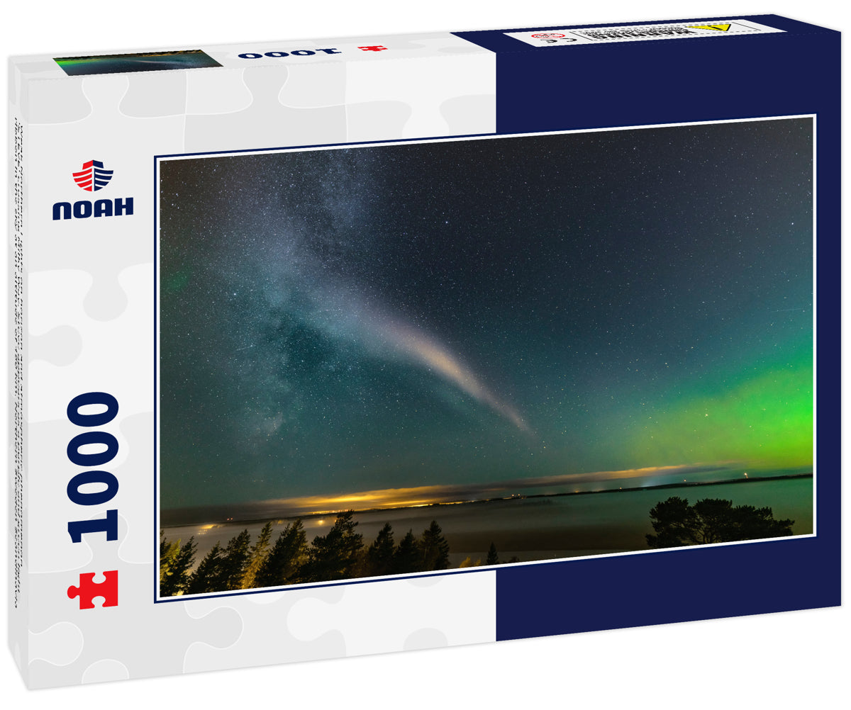 Weak Northern Lights on horizon and atmospheric phenomenon 'STEVE' crossing Milky Way. Steve appears as a purple and green light ribbon in the sky at an altitude of 450 km. Northern Sweden Scandinavia