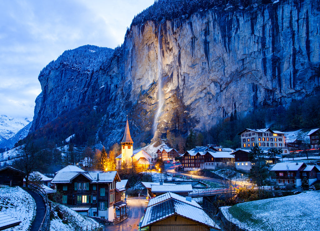 amazing touristic alpine village at night in winter with famous church and Staubbach waterfall Lauterbrunnen Switzerland Europe