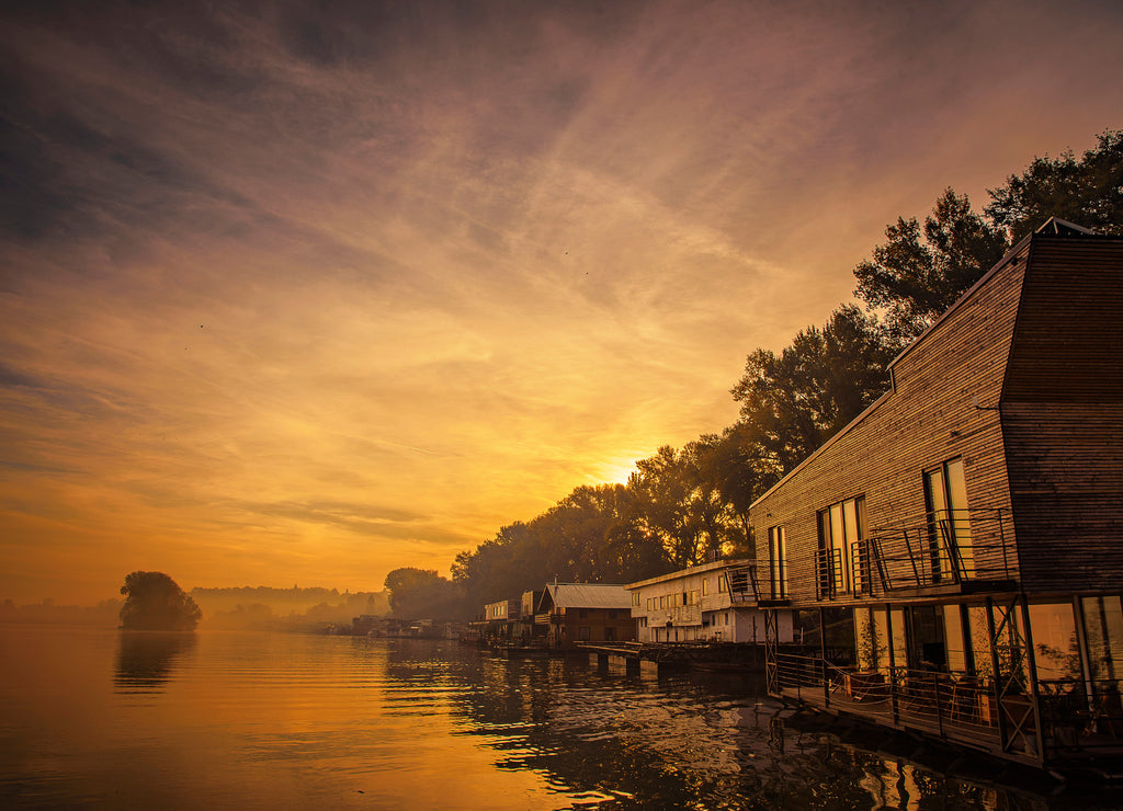 Amazing sunrise and water houses lined up on the shore of river Sava in Belgrade