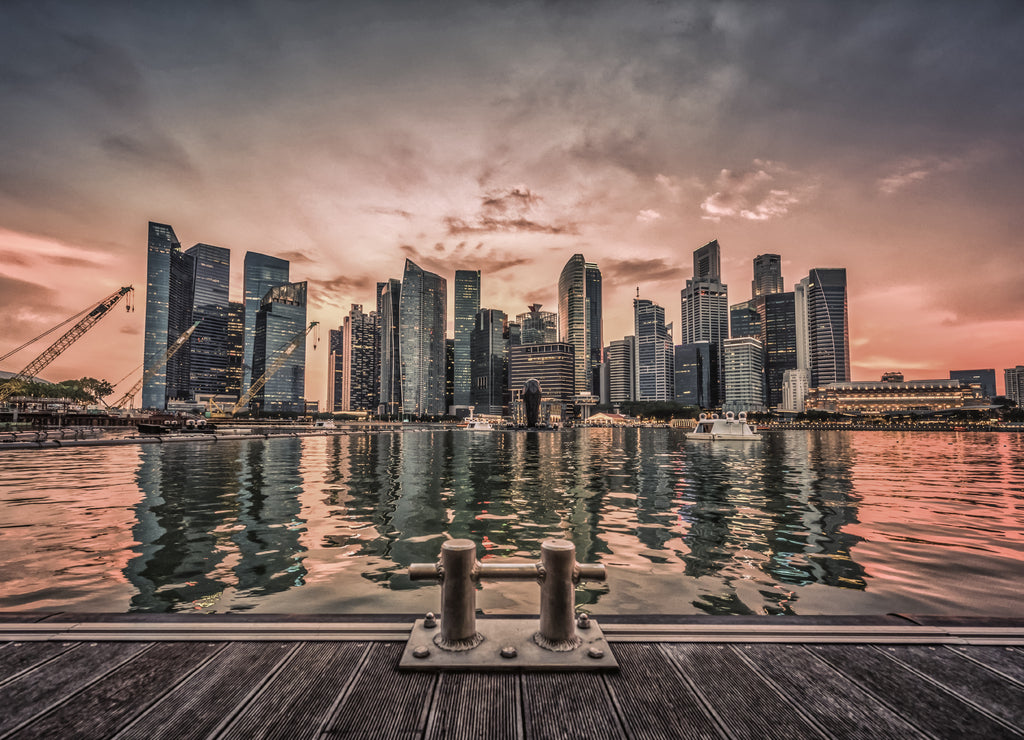 Singapore Skyline and view of business district downtown with wooden walkway on Marina Bay at sunset. Vintage tone