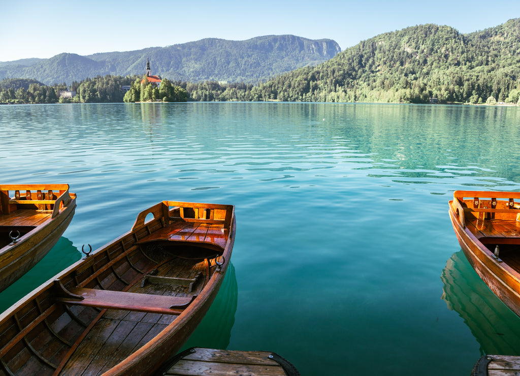 Lake Bled, wooden boats and pilgrimage church of the assumption of maria in Slovenia