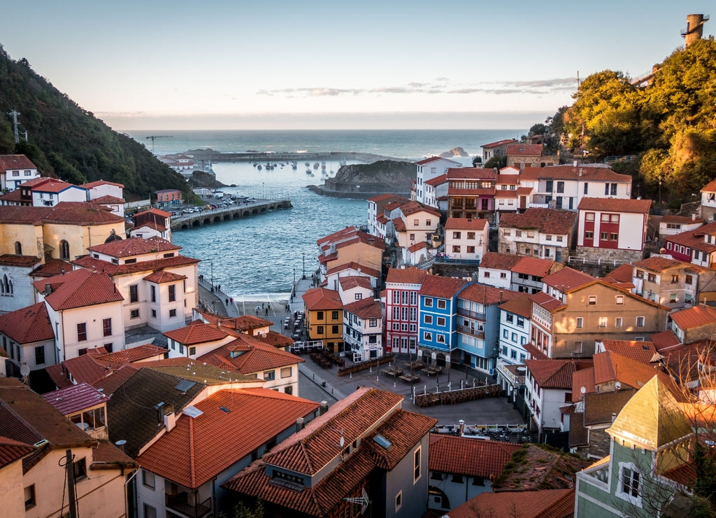 Landscape of Cudillero surrounded by hills and sea under the sunlight in Spain