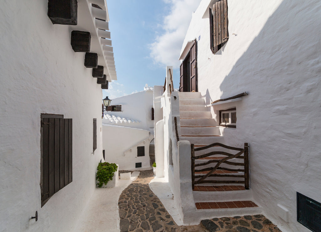 The narrow and white streets of Binibequer in the island of Menorca, Balearic islands, Spain
