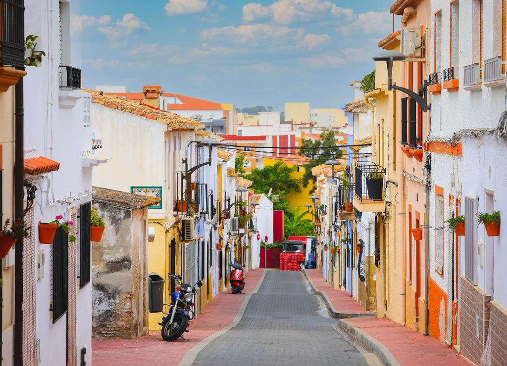 Selective focus on colourful buildings and facades on Denia street in Alicante at Mediterranean spain