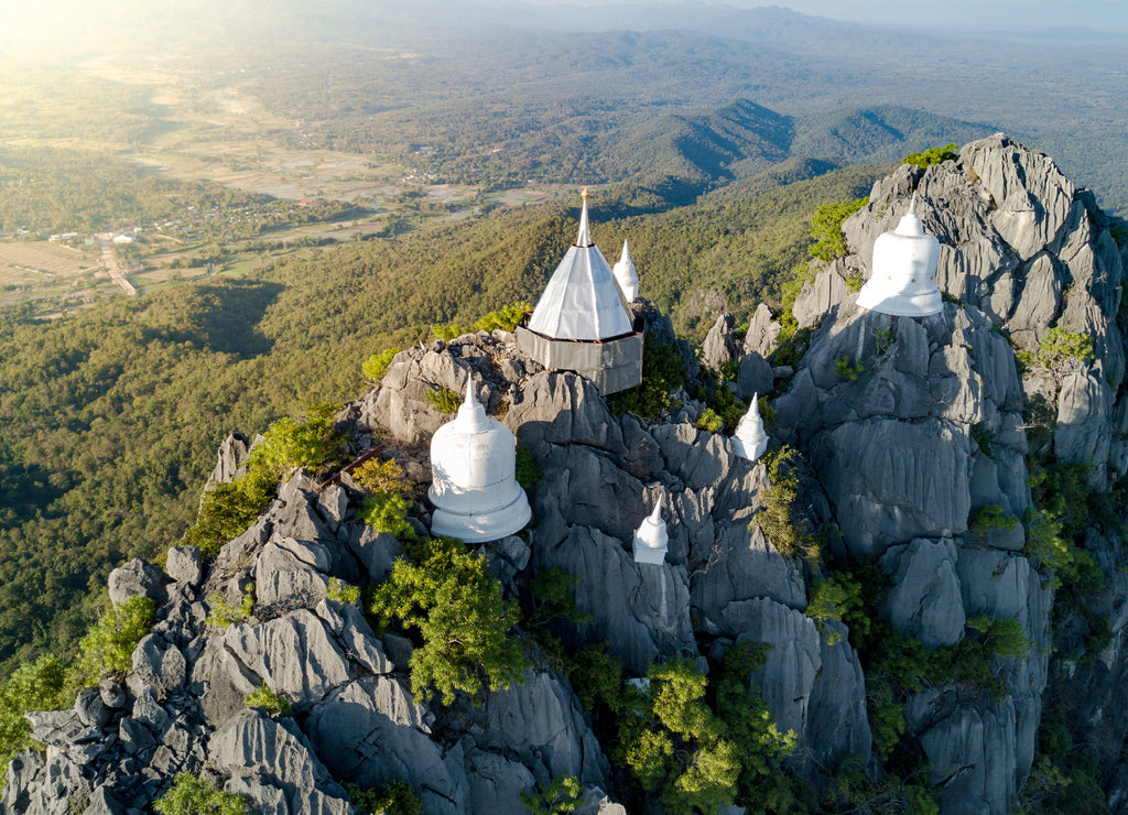 Spectacular aerial view of floating pagodas on the mountain cliff at Wat Chaloem Phra Kiat in Chae Hom District, Lampang province, Thailand