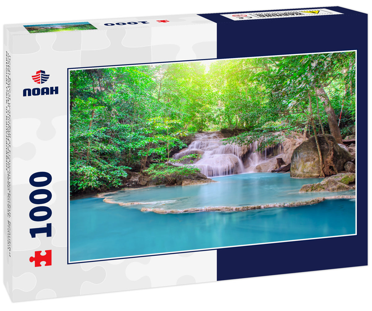 Deep forest waterfall at Erawan waterfall, beautiful waterfall with sunlight rays in deep forest, Erawan National Park in Kanchanaburi