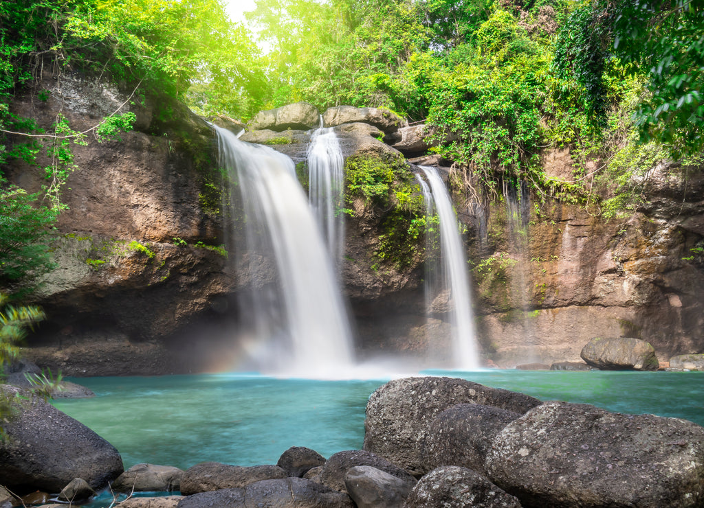 Travel to the beautiful waterfall in deep forest, soft water of the stream in the natural park at Haew Suwat Waterfall at Khao Yai National Park