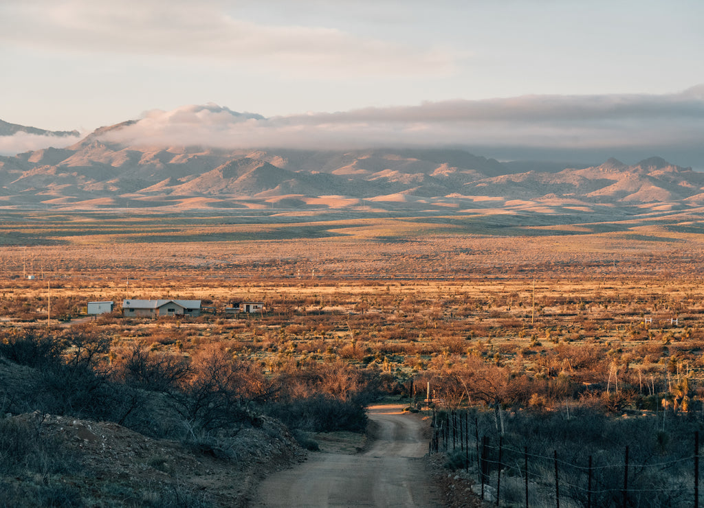 Dirt road and mountains at sunset in the desert of eastern Arizona