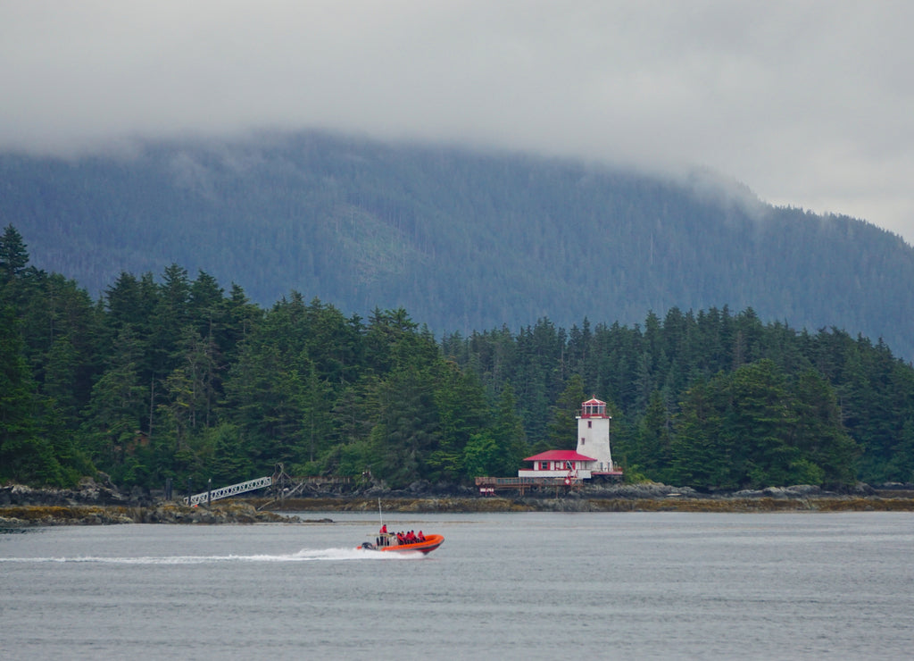 Sitka, Alaska, USA: A small lighthouse on an island in the waters off of Sitka, Alaska, under a cloudy sky
