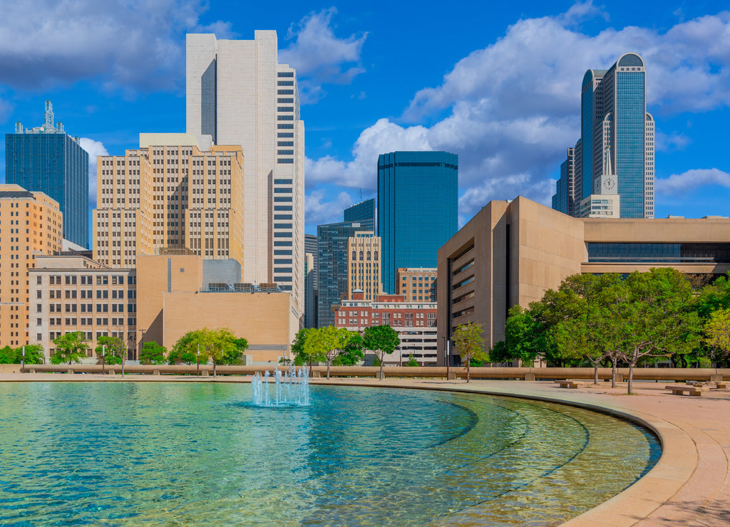 Downtown Dallas buildings line a refreshing fountain courtyard rest area, Texas