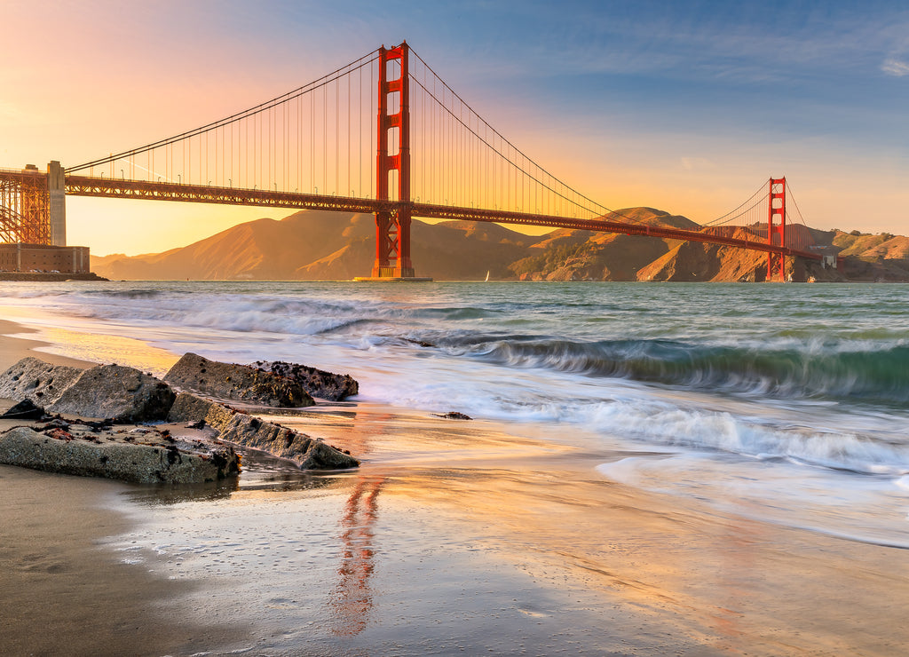 Sunset at the beach by the Golden Gate Bridge in San Francisco California