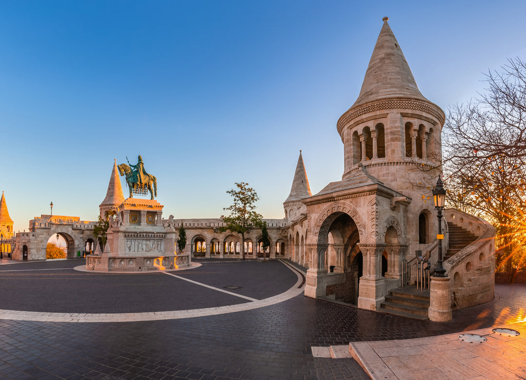 Budapest, Hungary - Panoramic view of the Fisherman's Bastion (Halaszbastya) at sunrise with autumn foliage and clear blue sky
