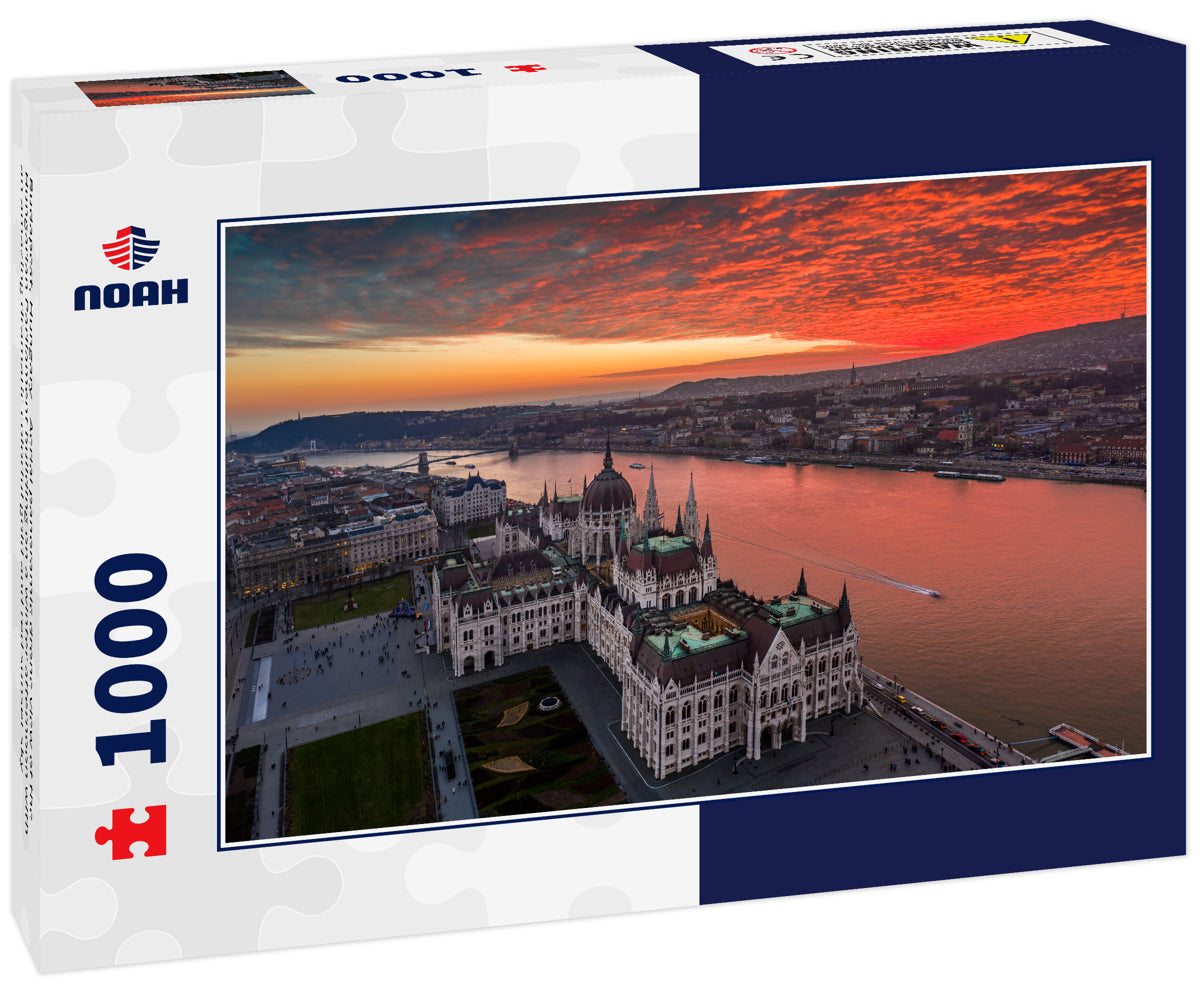 Budapest, Hungary - Aerial panoramic drone view of the Hungarian Parliament building on a winter afternoon with an amazing dramatic colorful gold and red sunset sky