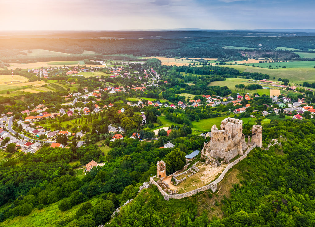 Csesznek, Hungary - Aerial panoramic view of the hilltop Castle of Csesznek and Csesznek city at sunset on a sunny summer afternoon