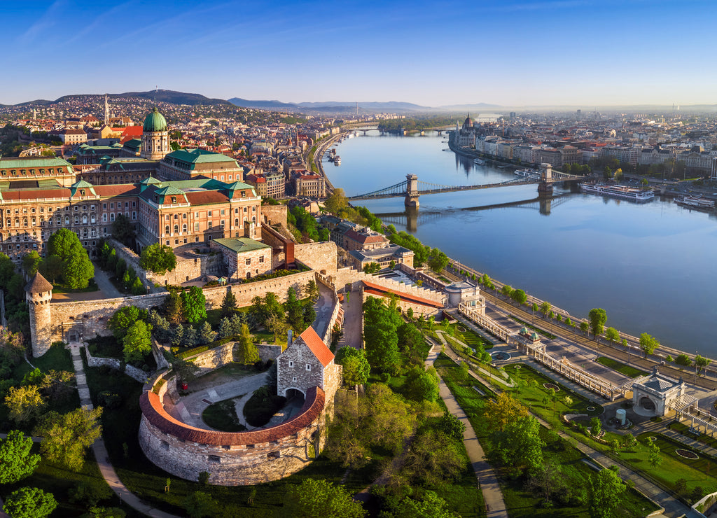 Budapest, Hungary - Aerial panoramic skyline view of Buda Castle Royal Palace with Szechenyi Chain Bridge, St.Stephen's Basilica, Parliament of Hungary and Matthias Church on a summer morning