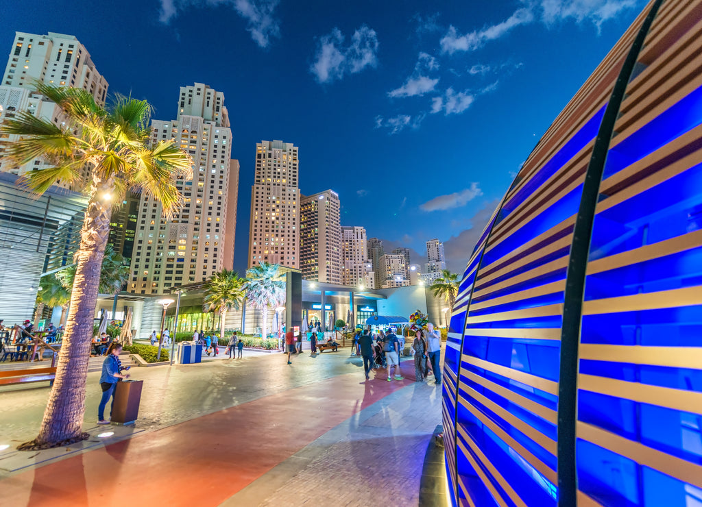 Dubai Marina skyline with city promenade at dusk United Arab Emirates