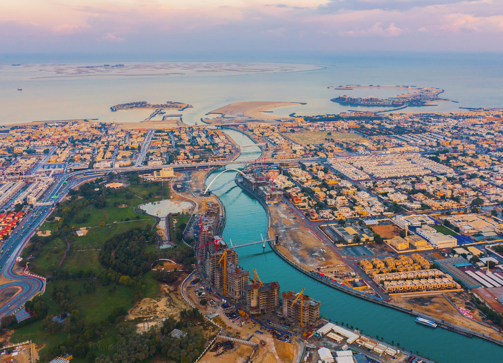 Aerial view of Tolerance bridge. Structure of architecture with lake or river, Dubai Downtown skyline, United Arab Emirates