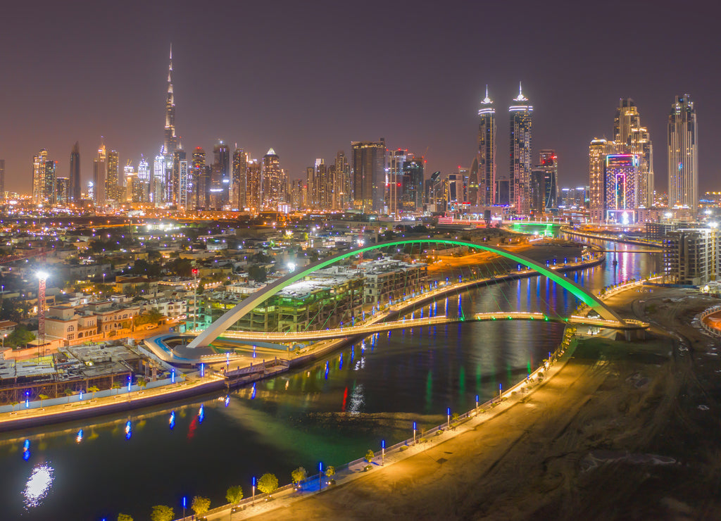 Aerial view of Tolerance bridge and Dubai downtown skyline. Structure of architecture with lake or river, United Arab Emirates