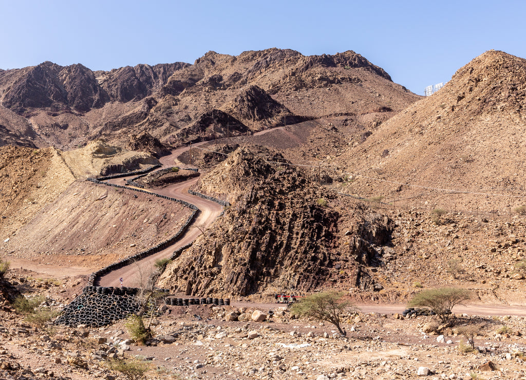 Hatta Wadi Hub mountain carting downhill trail with car tires fence, Hajar Mountains, United Arab Emirates