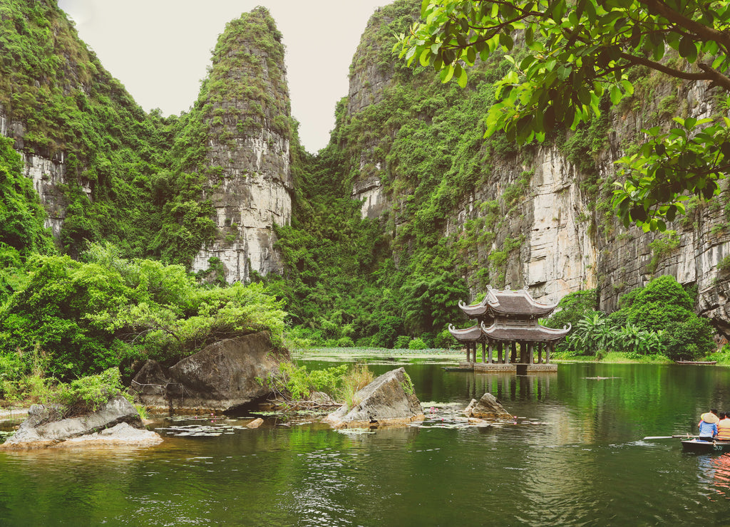 Tourists on rowboat at the Trang An Landscape Complex in the Ninh Binh Province of Vietnam