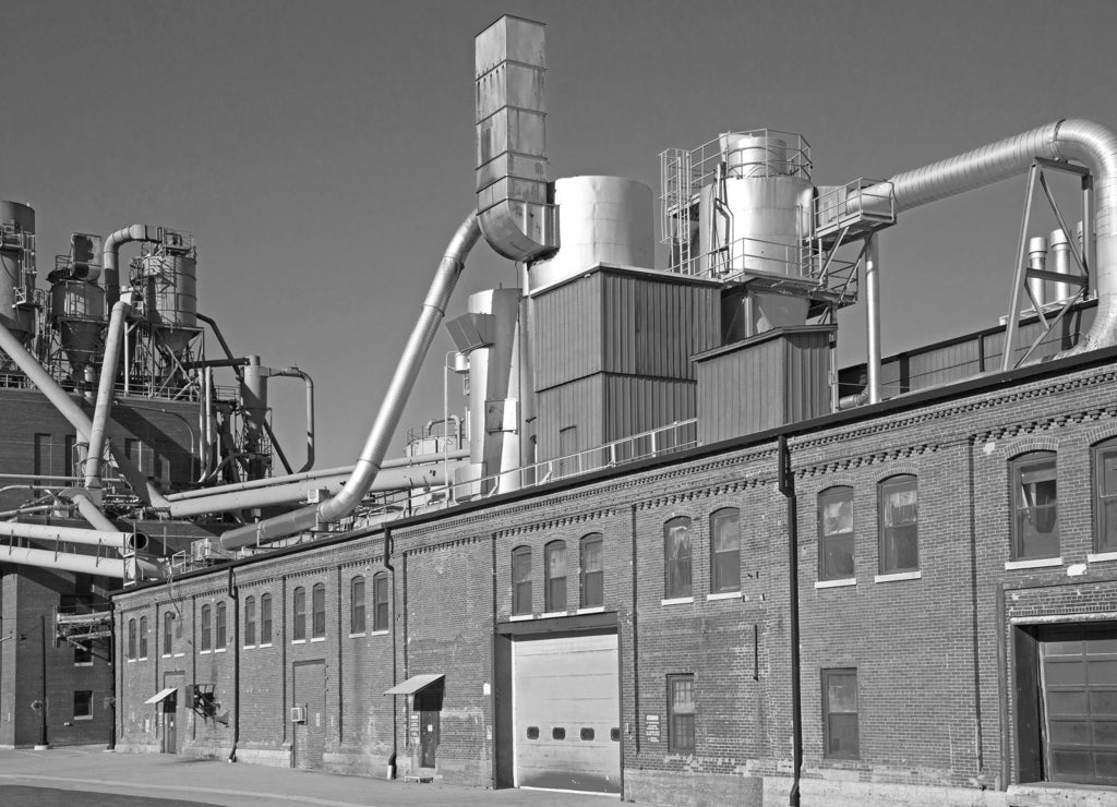 A manufacturing plant in the historic Millwork District of Dubuque under a blue sky on a warm day, Iowa USA in black white