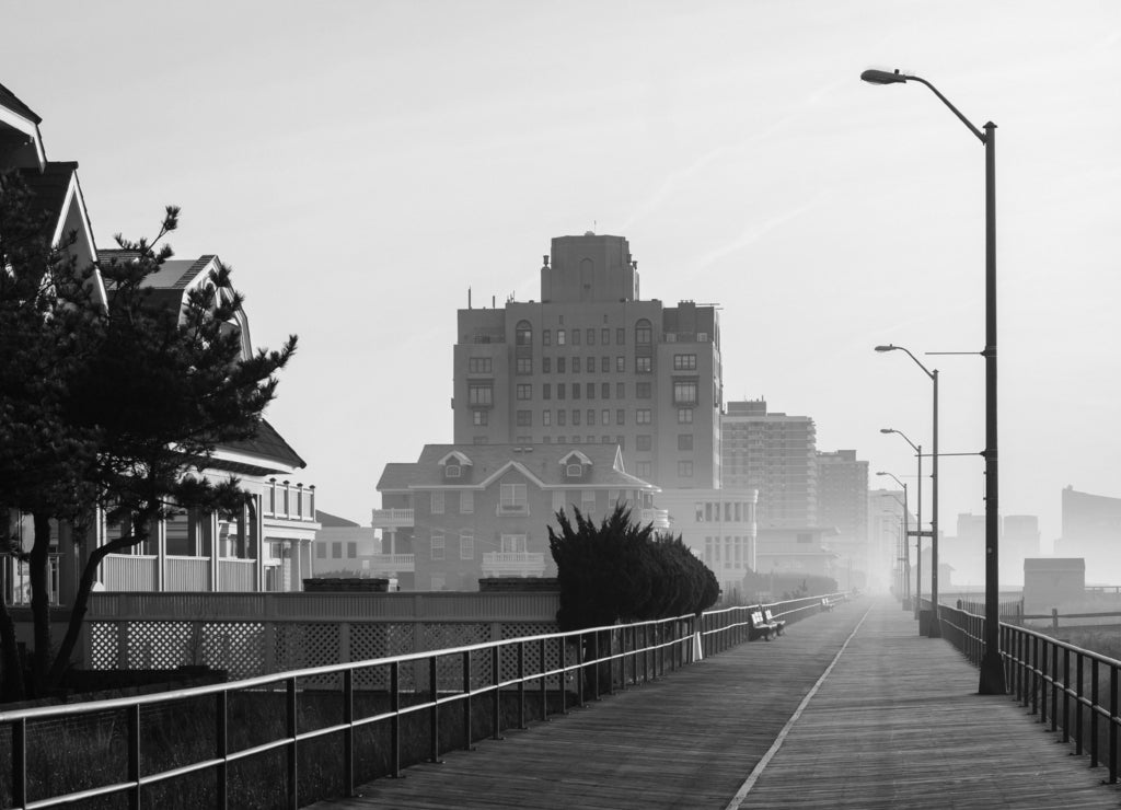 The boardwalk in sunrise in Ventnor City, New Jersey in black white
