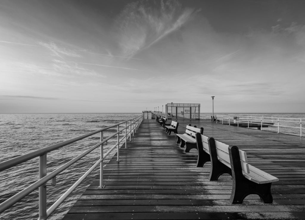The fishing pier at sunrise in Ventnor City, New Jersey in black white