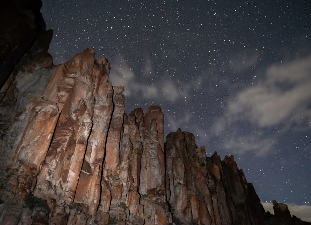 Stars and Clouds at Night over Stone Cathedral volcanic rock pillars in Basin and Range National Monument, Lincoln COunty, Nevada, USA