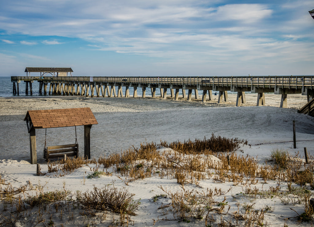 Tybee Island pier in Southern Georgia United States on the beach of the Atlantic Ocean, and a swing