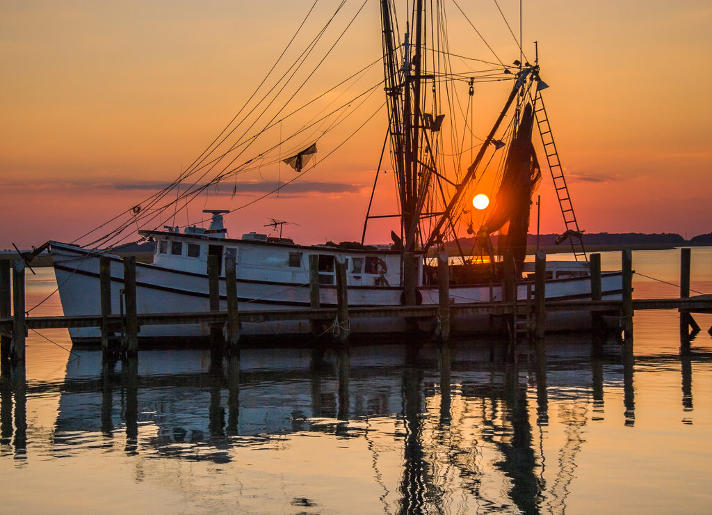 Sunset on a shrimp boat moored at the Port Royal harbor, Georgia