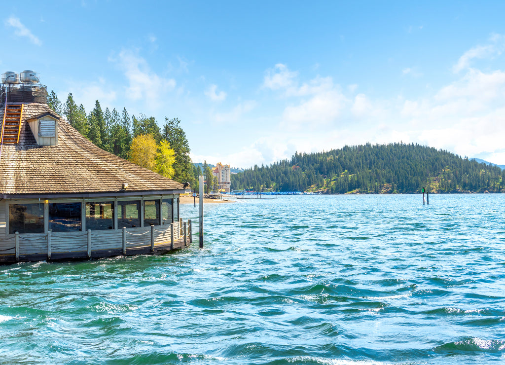 The lakefront downtown, marina, beach and Tubbs Hill are viewed from a floating restaurant on the lake in Coeur d'Alene, Idaho, USA