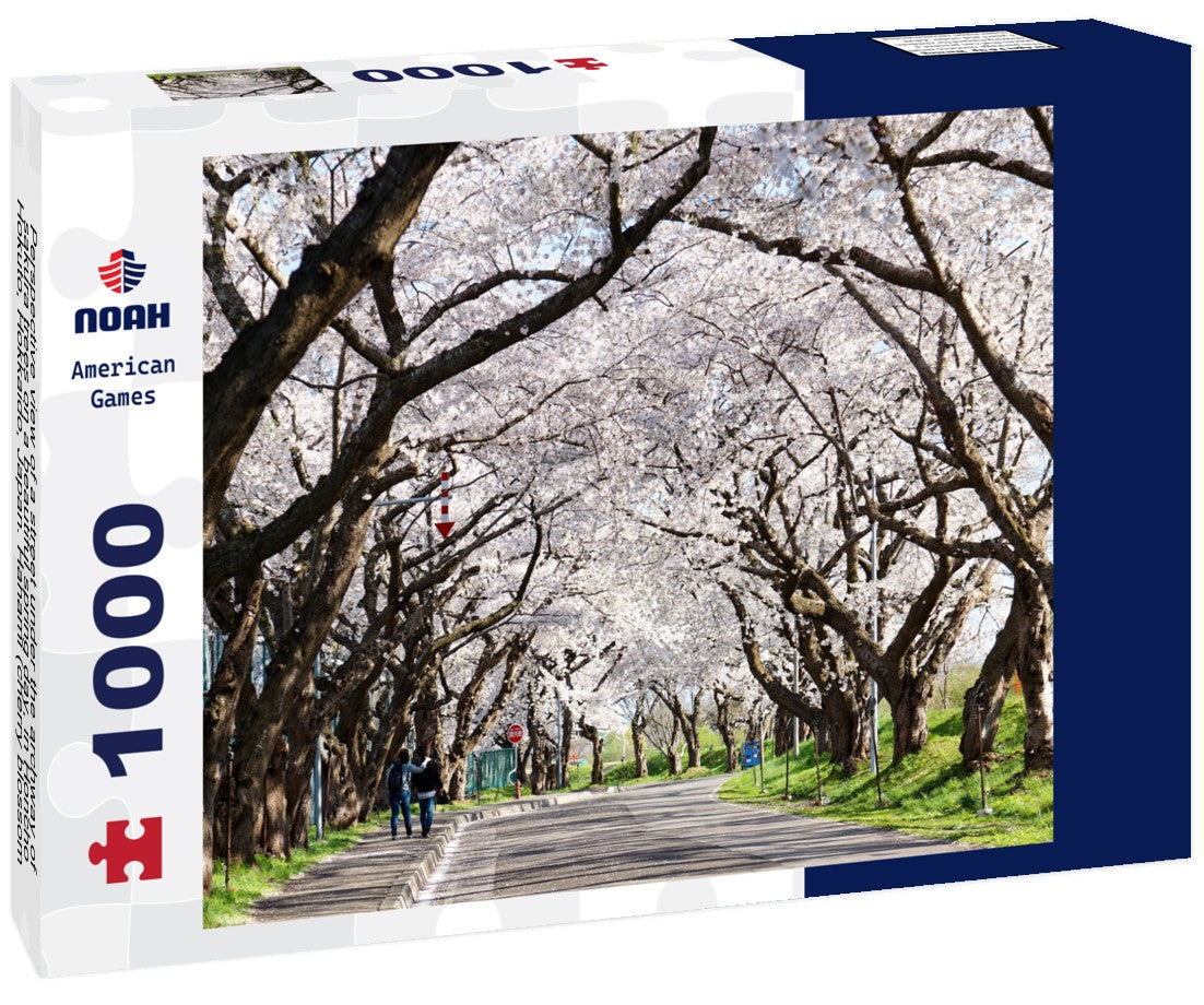 Perspective view of a street under the archway of sakura trees on a beautiful spring day, in Honcho, Hokuto, Hokkaido, Japan. Hanami (cherry blossom viewing) is a popular activity in Japan 1000pc Puzzle