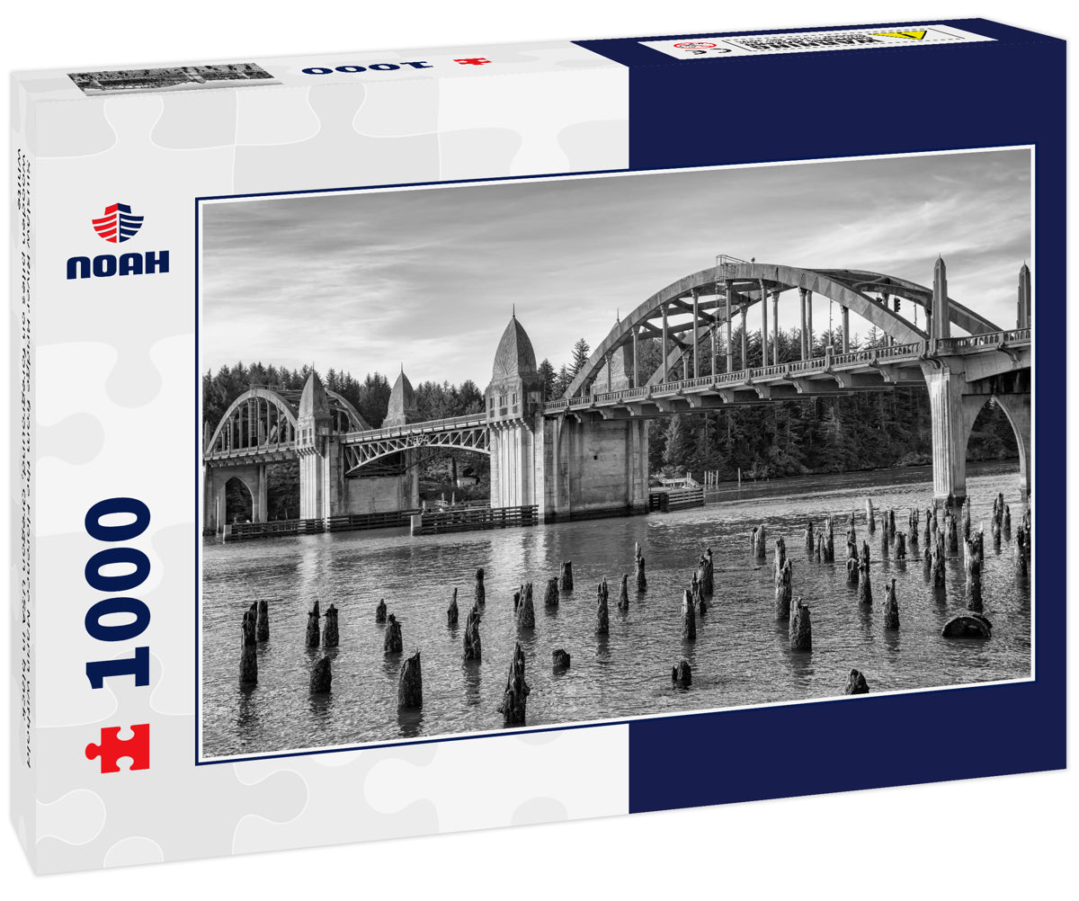 Siuslaw River Bridge from the Florence Marin withold wooden piles on foreground, Oregon USA in black white