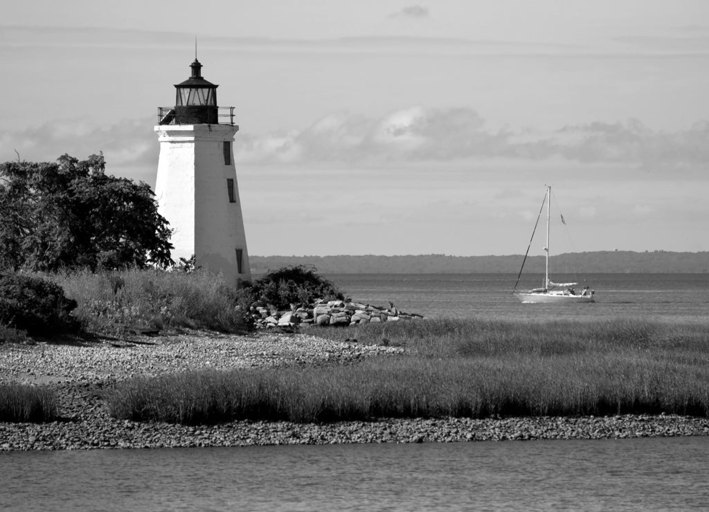 Sailboat Passing by Black Rock Harbor Lighthouse in Connecticut in black white