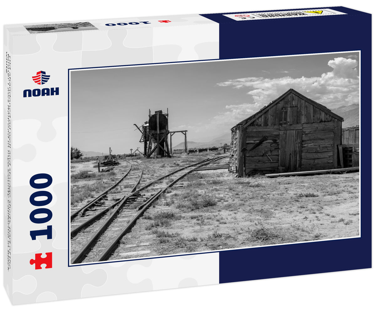 Old abandoned oil well and storage sheds, part of the former Laws Railroad in Inyo County California in black white