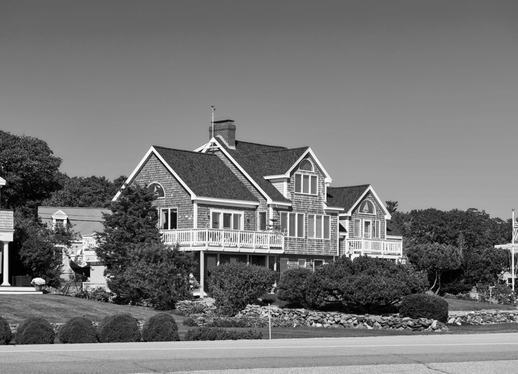 United States flag at suburban neighborhood. New Hampshire, USA in black white