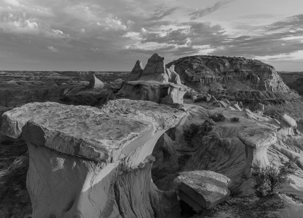 Sculpted badlands formations at first light in Theodore Roosevelt National Park, North Dakota, USA in black white