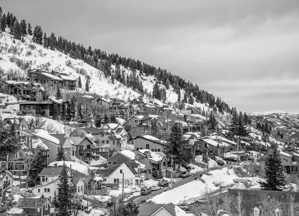 Colorful cabins on a mountain with snow during winter season in Park City Utah in black white