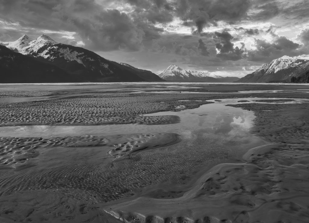 Sunset storm clouds over the Chilkat River, Alaska in black white