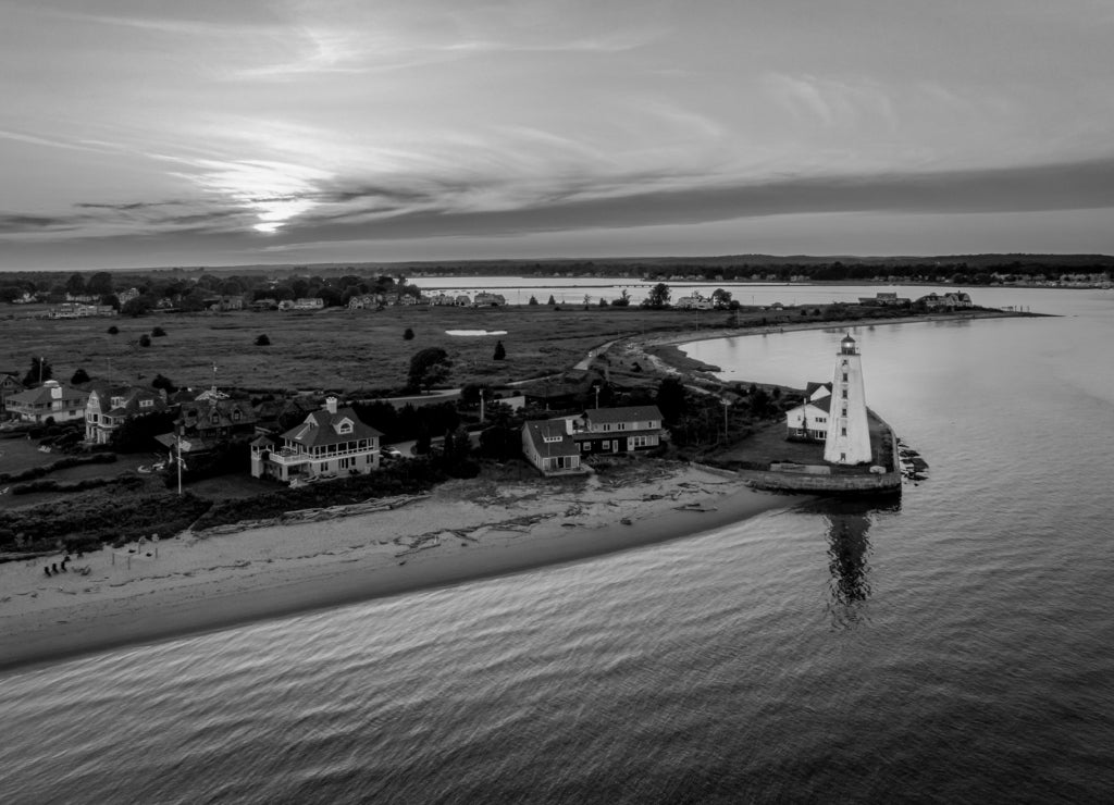 Summer sunset in Old Saybrook along the Connecticut River with Lynde Lighthouse in the foreground and a summer sunset in black white