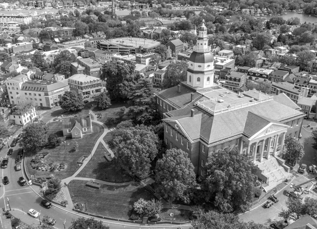 Aerial view of Maryland State House capitol building white dome and state circle with colonial houses in Annapolis on a sunny weekend afternoon in black white